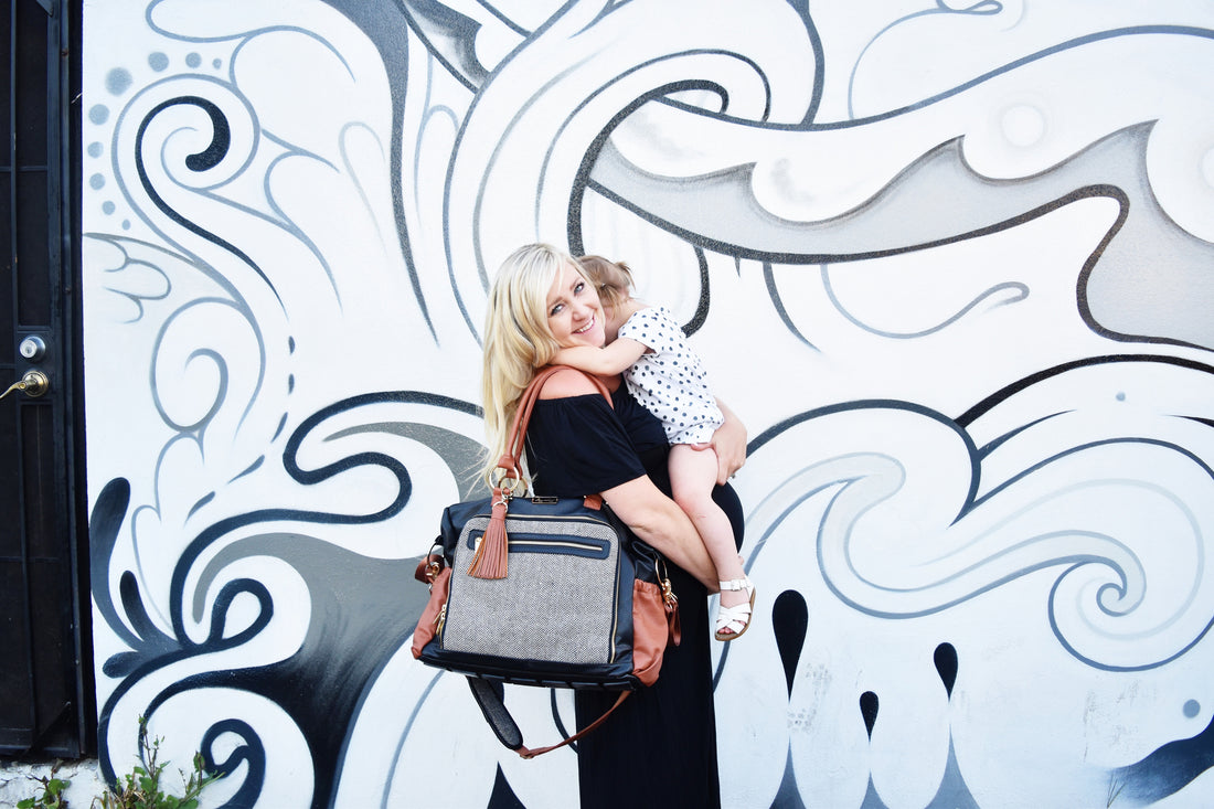 Pregnant woman holding her child