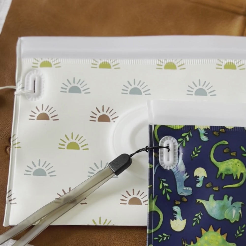 video:Take & Travel Pouch™ Reusable Wipes Case Diaper Bag Accessory Itzy Ritzy Raining Dinos Desert Sunrise Darling Dinos