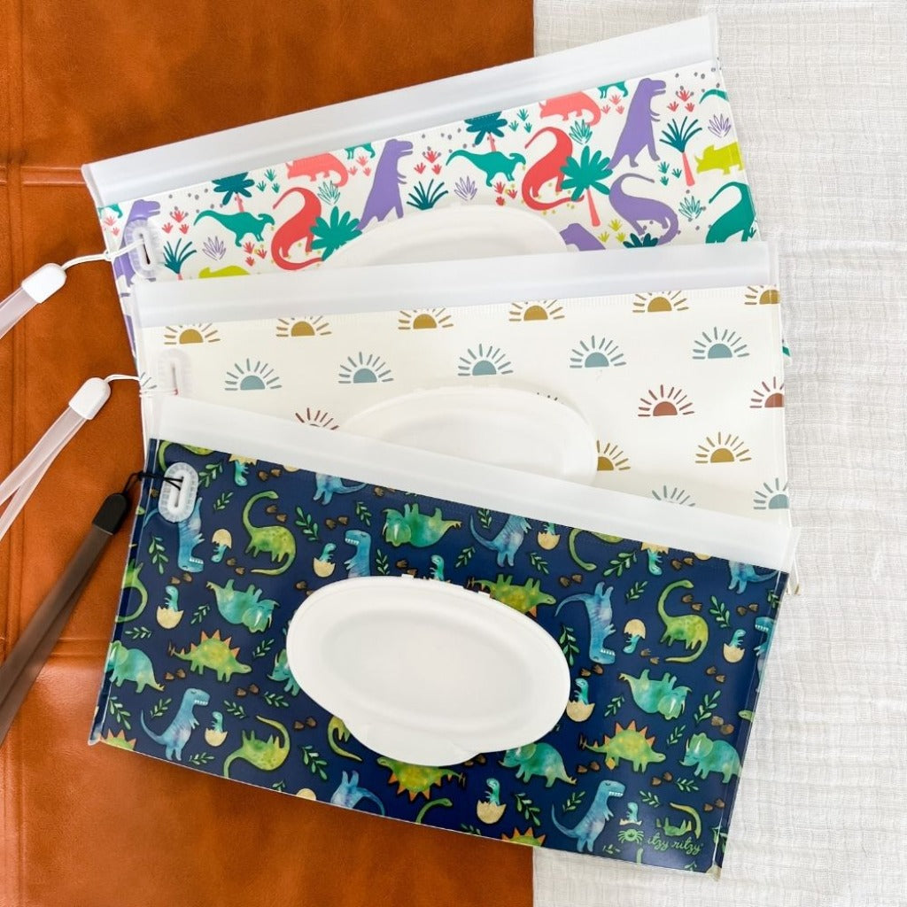 Take & Travel Pouch™ Reusable Wipes Case Diaper Bag Accessory Itzy Ritzy Darling Dinos Raining Dinos Desert Sunrise